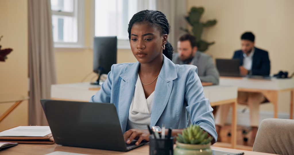 HR professional working at a laptop in an office